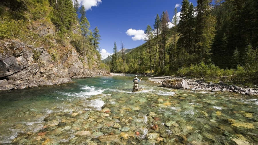 Relax And Enjoy The Peacefulness Of Fly Fishing Wallpaper