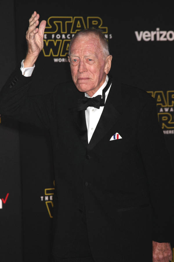 Renowned Swedish Actor, Max Von Sydow, Waving In Style Wallpaper