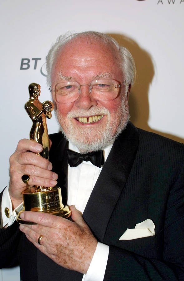 Richard Attenborough Holding A Golden Trophy Wallpaper