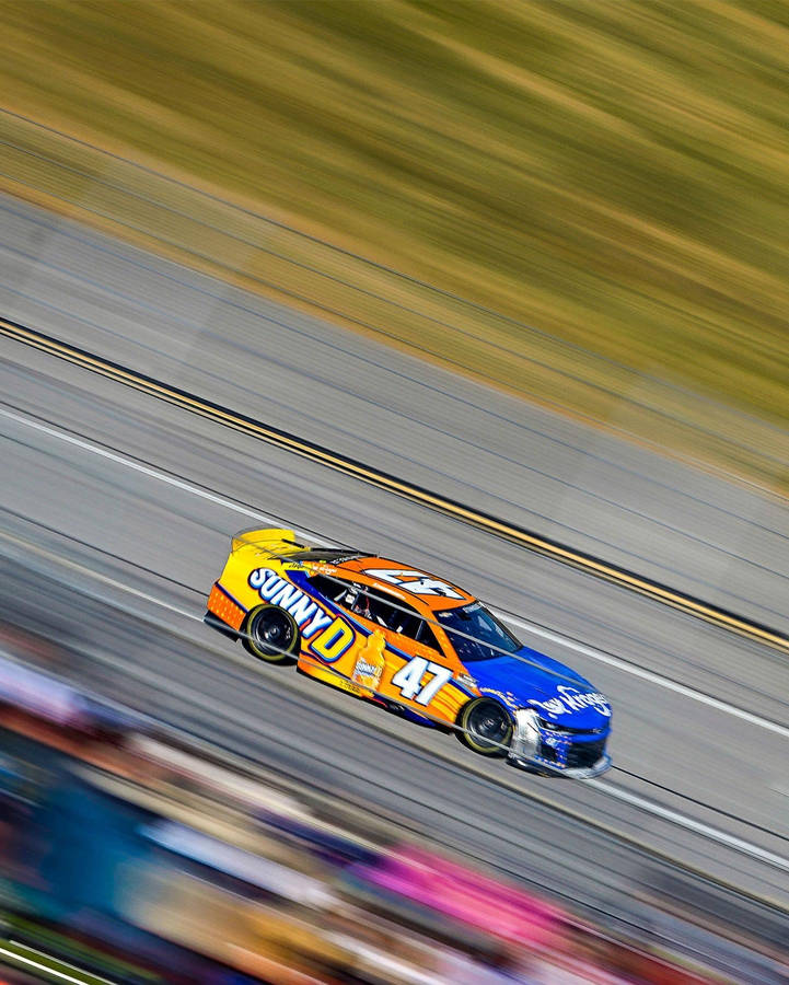 Ricky Stenhouse Jr. Racing At High Speed Wallpaper