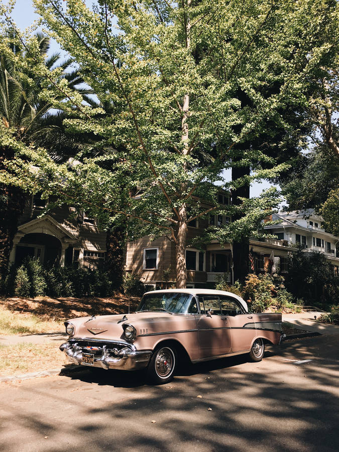 Ride In Vogue In A Vintage Pink Car Wallpaper