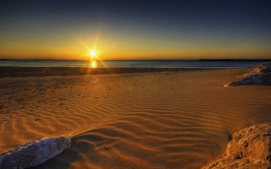 Rising Sun On Sandy Beach Wallpaper