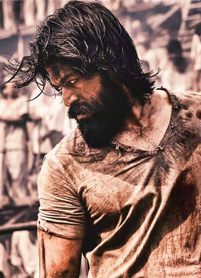 Rocky Bhai Showcasing His Signature Rugged Look With A Fierce Beard And Intense Eyes. Wallpaper