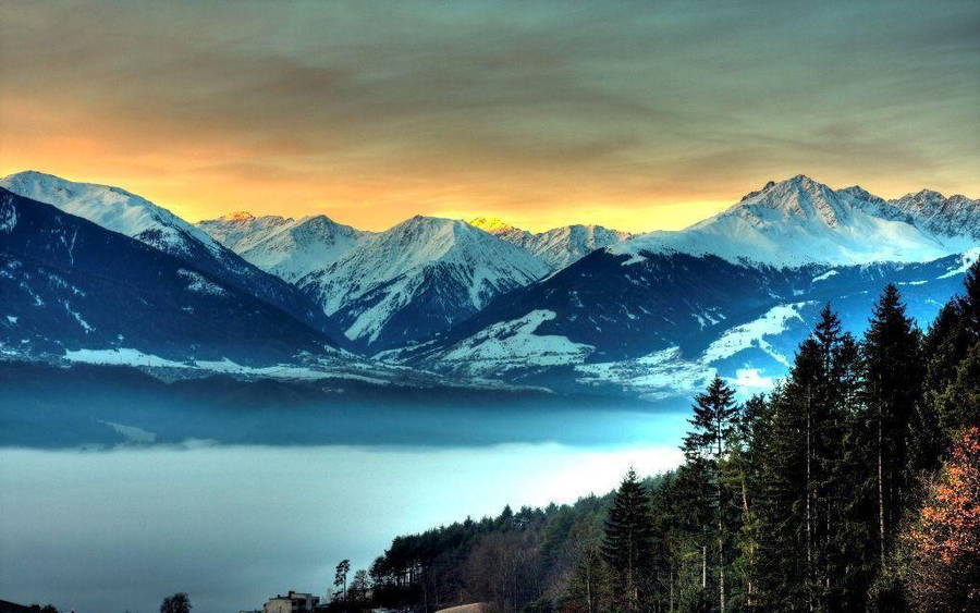 Rocky Mountain With Orange Sky Overhead Wallpaper