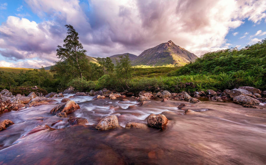 Rocky Stream Beside Hillside Wallpaper