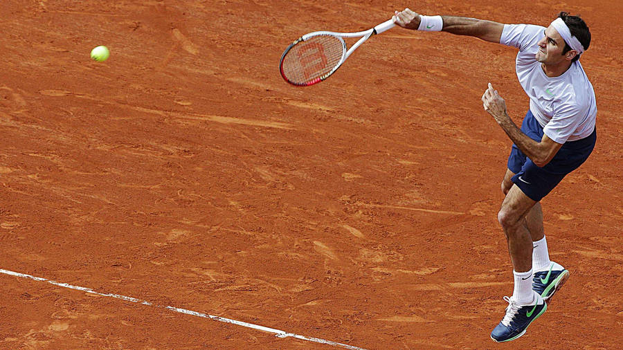 Roger Federer Serving At The French Open Wallpaper