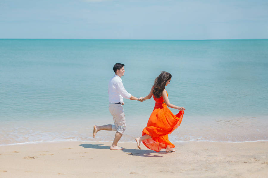 Romantic Couple Stroll On The Beach Wallpaper