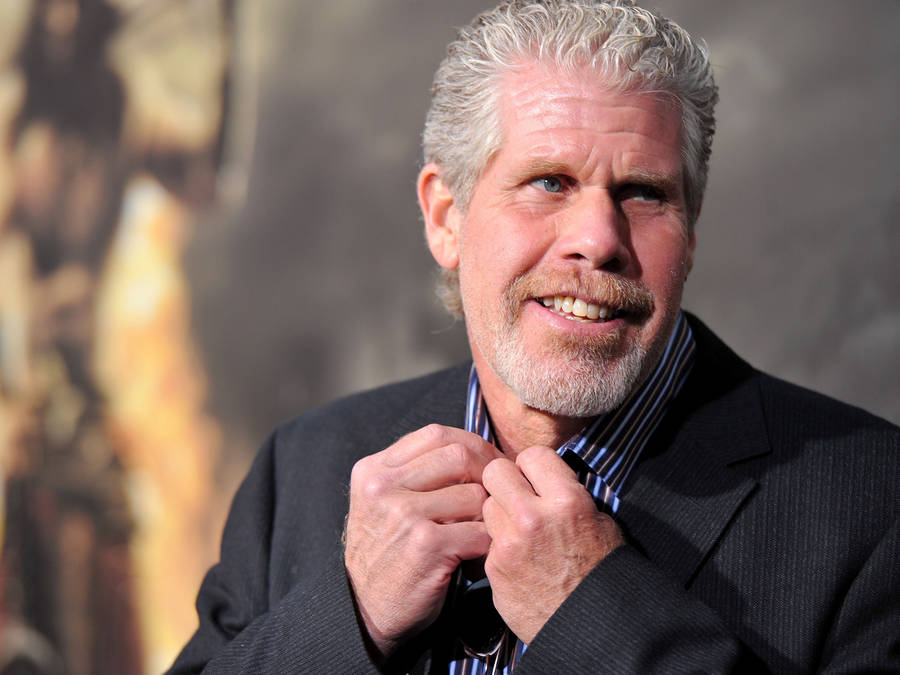 Ron Perlman Fixing His Polo Button Wallpaper