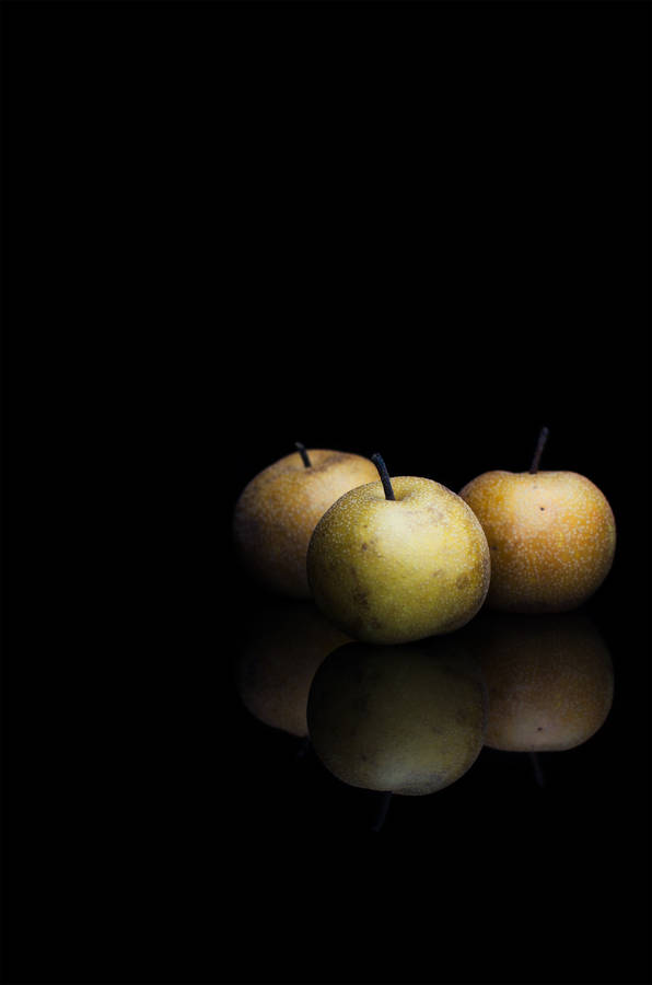 Round Fruits Against Black Background Wallpaper