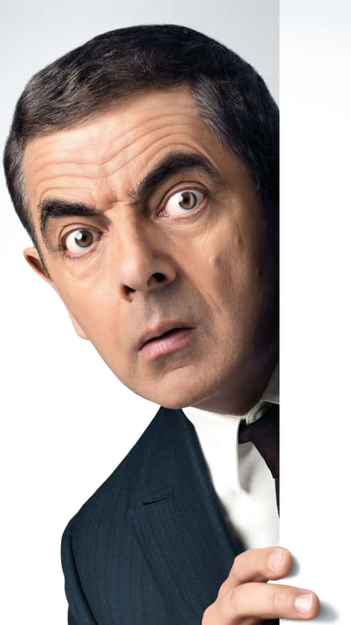 Rowan Atkinson Peeking Around Edge Wallpaper