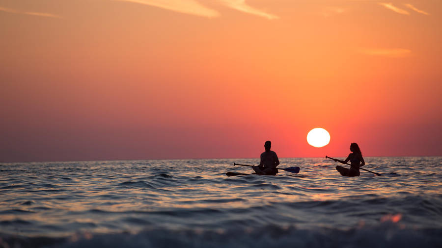 Rowing Lovers In Sunset Wallpaper