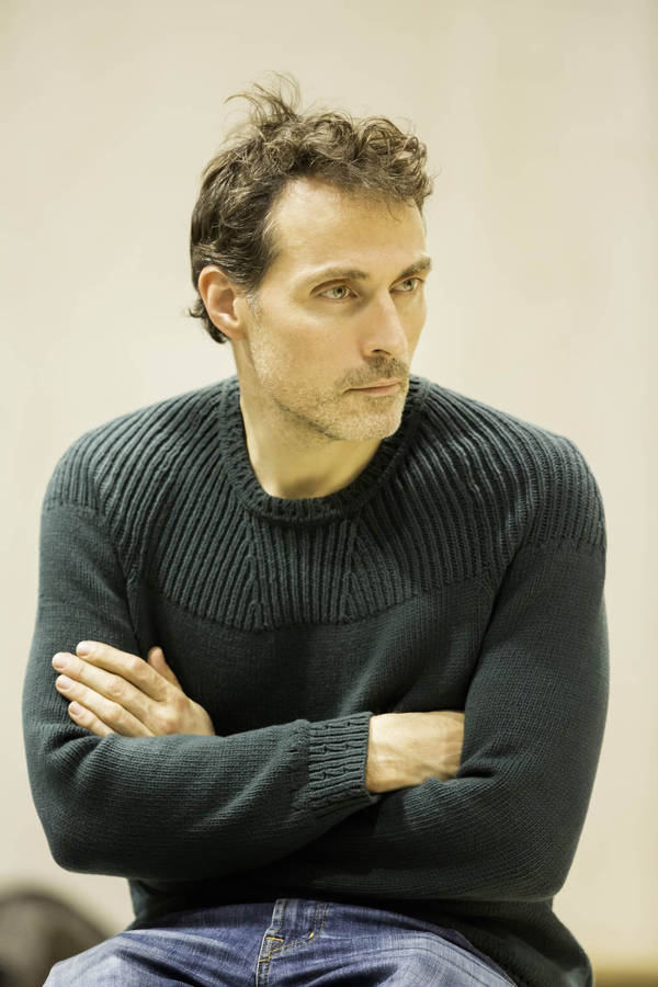 Rufus Sewell Posing With Crossed Arms In Black Sweater Wallpaper