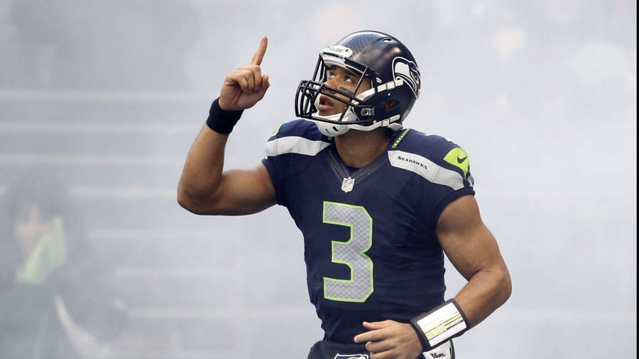 Russell Wilson Pointing Up Surrounded By Fog Wallpaper
