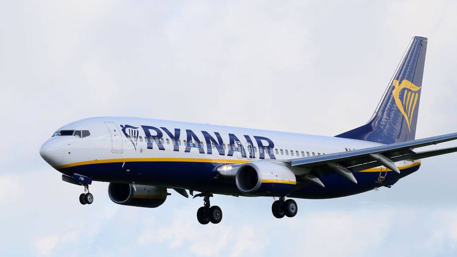 Ryanair Flying In Cloudy Sky Wallpaper