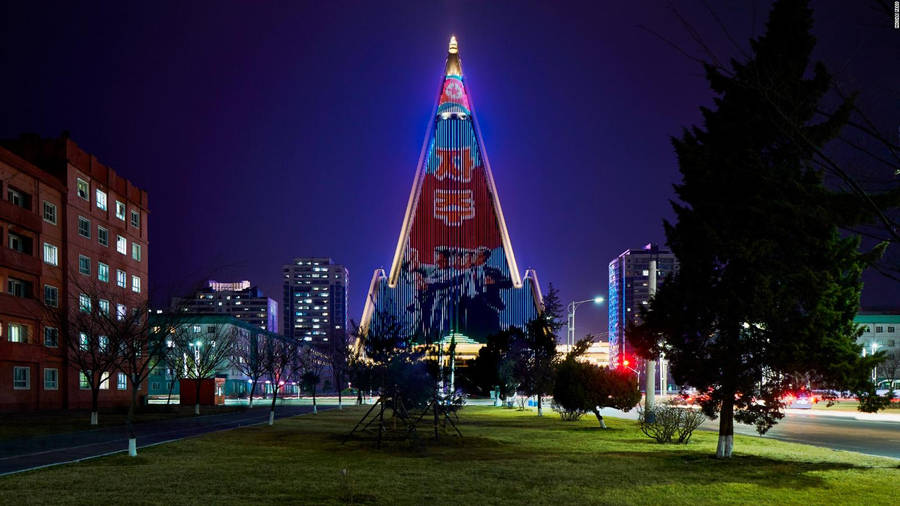 Ryugyong Hotel Illuminated At Night In Pyongyang, North Korea Wallpaper