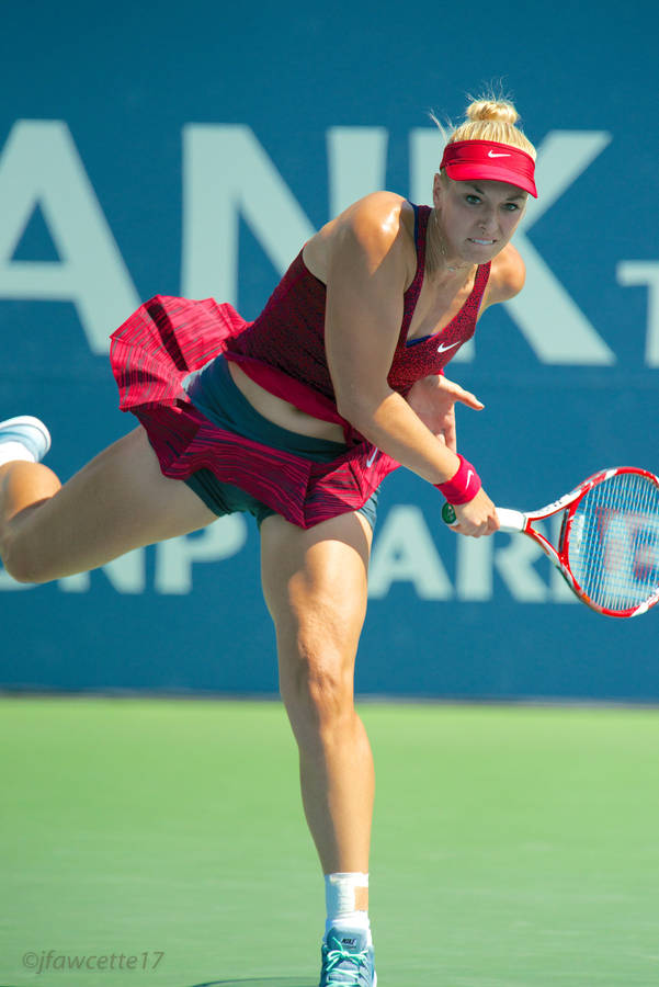 Sabine Lisicki In Action With Her Red Tennis Racket Wallpaper