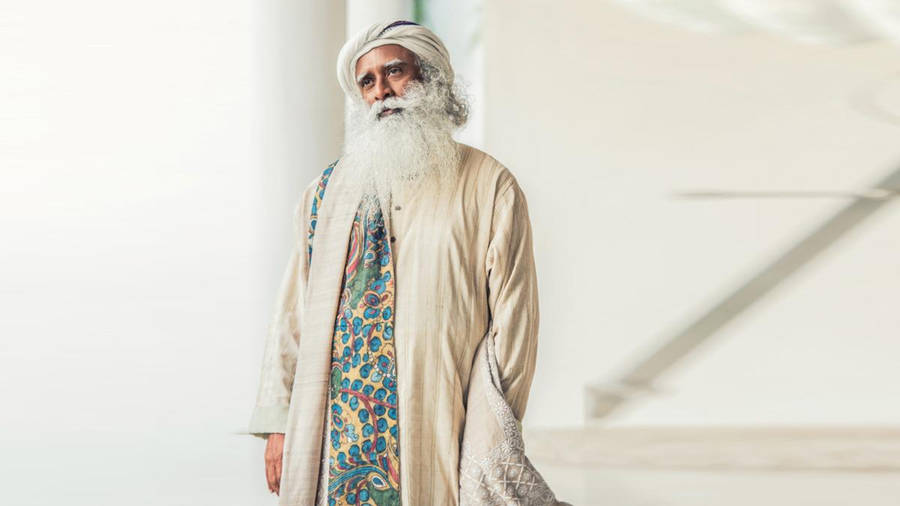 Sadhguru Standing On A White Hall Wallpaper