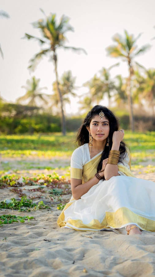 Sai Pallavi Seated On The Sand Wallpaper