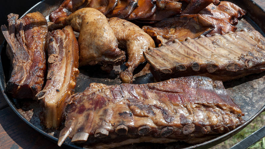 Savory Chicken And Pork Parrilla Cooking On An Open Grill Wallpaper