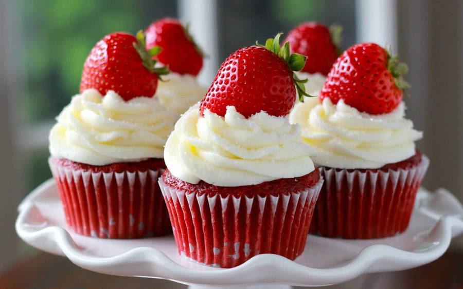 Scrumptious Red Cupcakes With Fresh Strawberries On Top Wallpaper