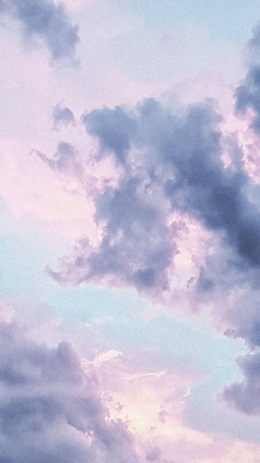 Serene Sky - A Portrait Of Gray, Pink, And Blue Clouds Wallpaper