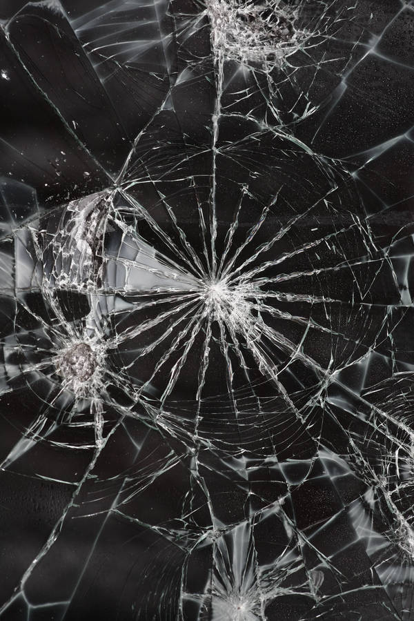 Shattered Illusions: A Broken Glass Close-up Wallpaper