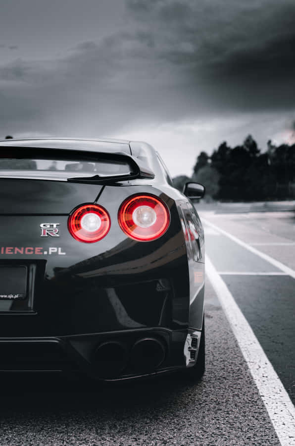 Shiny Black Nissan R35 Gtr Dark Clouds Wallpaper