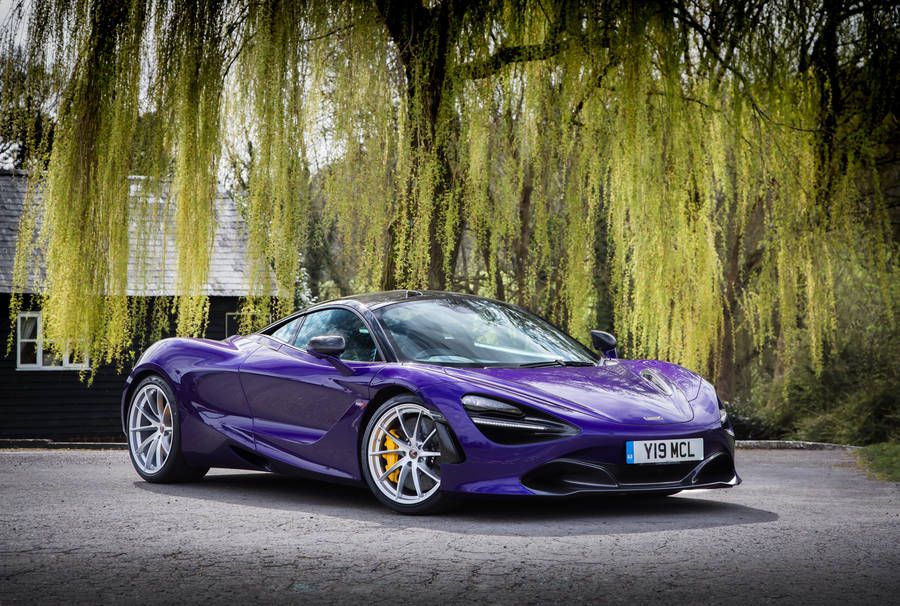 Showcasing Power And Luxury: The Stunning Mclaren 720s In Violet Wallpaper