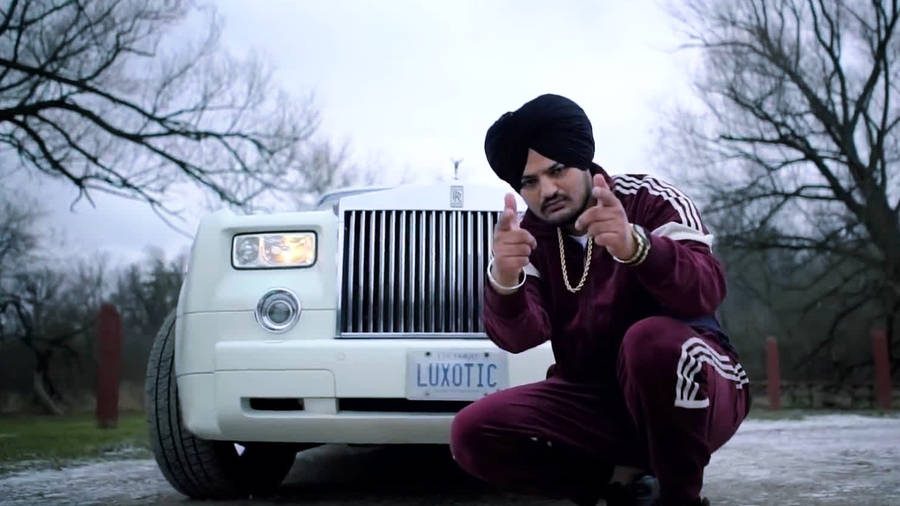 Sidhu Moose Wala With A Rolls Royce Wallpaper