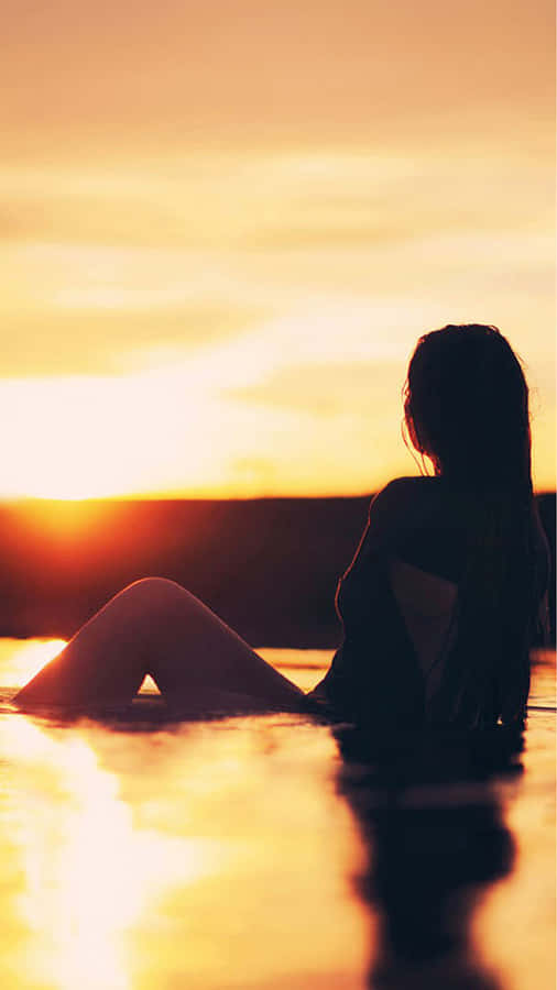 Silhouette Of Girl On Beach's Golden Sunset Wallpaper