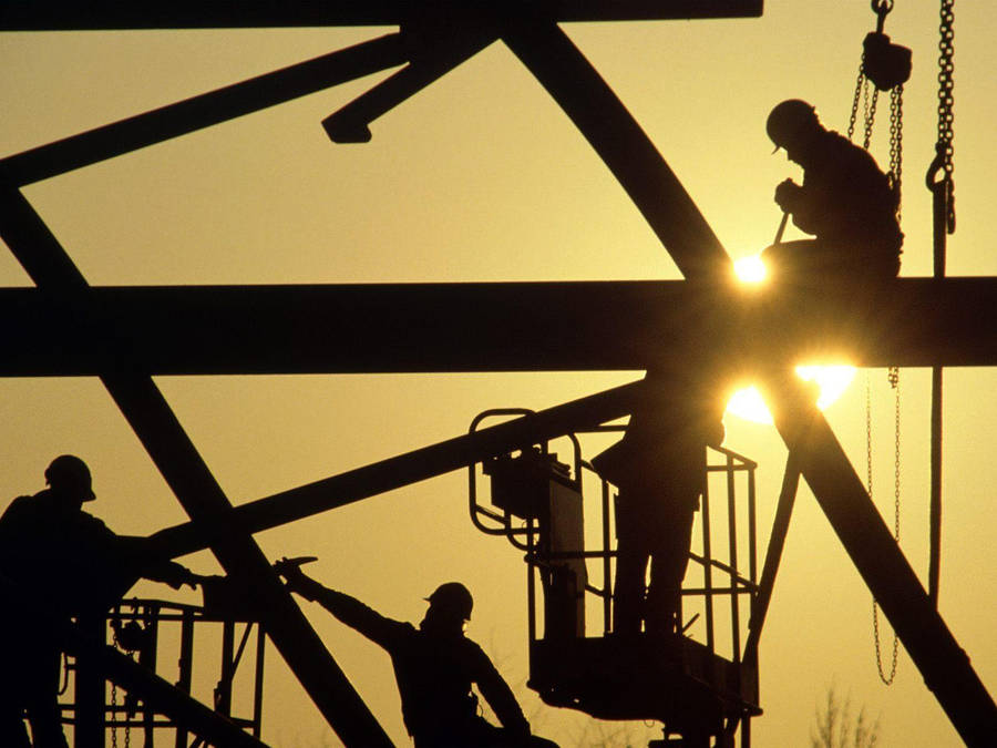 Silhouetted Construction Workers At Work Wallpaper