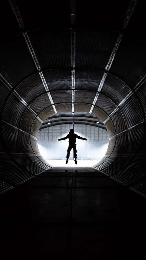 Silhouetted Figurein Tunnel Wallpaper