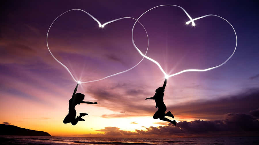 Silhouettes Jumping Heart Trails Sunset Wallpaper