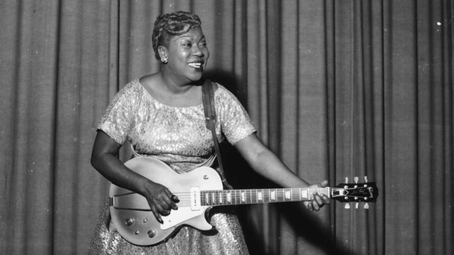 Sister Rosetta Tharpe Joyfully Playing Guitar Wallpaper