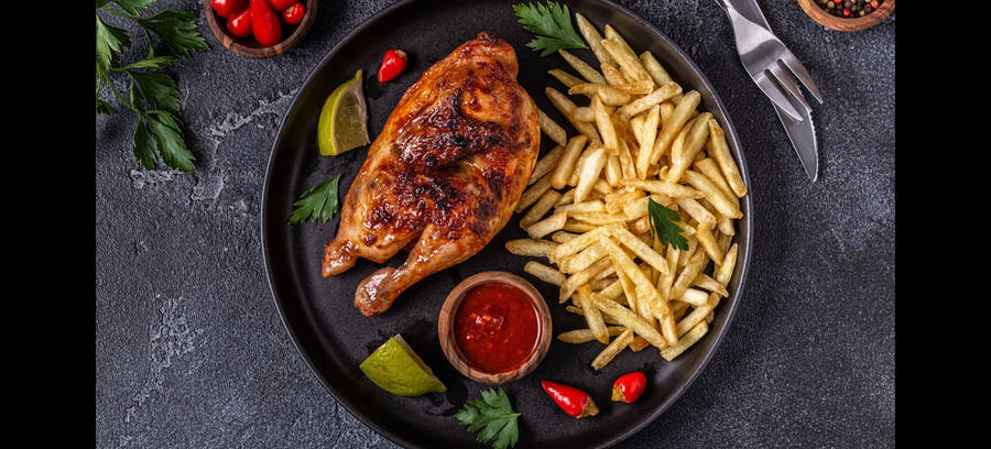 Sizzling Half-roasted Peri Peri Chicken With French Fries Wallpaper