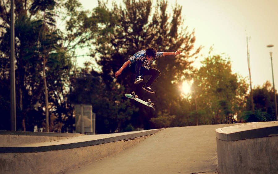Skater Boy Nollie Trick At Sunset Wallpaper
