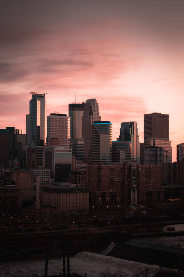 Skylines And Pink Clouds City Background Wallpaper