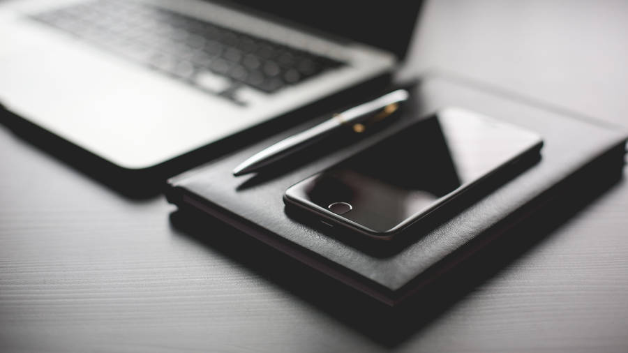 Sleek Black Home Office Desk Wallpaper