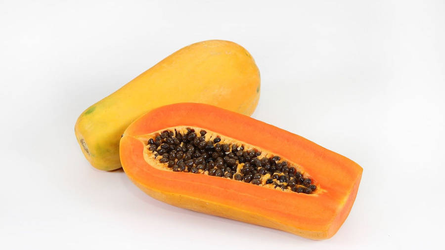 Sliced Papaya Fruits With Seeds White Wallpaper