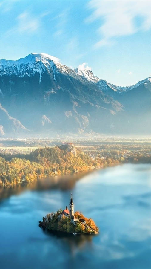 Slovenia's Scenic Lake Under The Clear Blue Sky Wallpaper