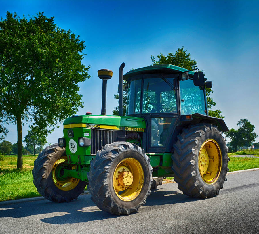 Small John Deere Tractor On Road Wallpaper