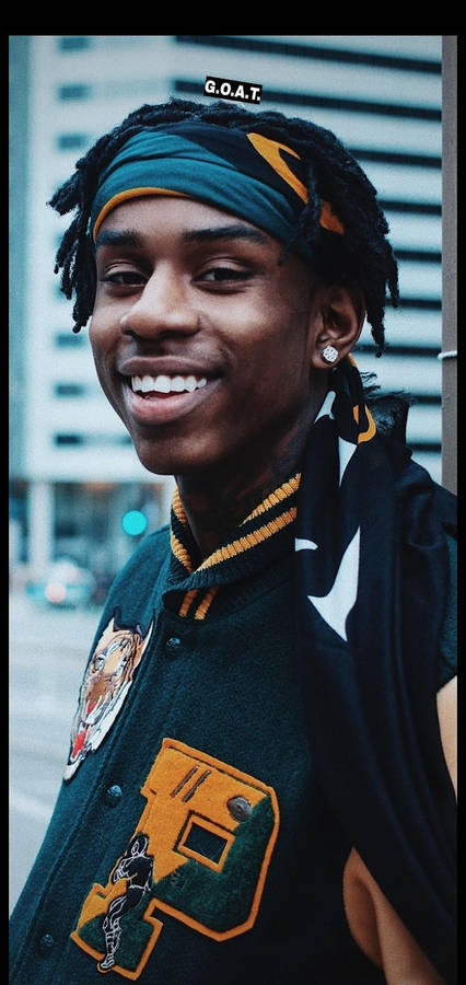 Smiling Polo G In Varsity Jacket Wallpaper