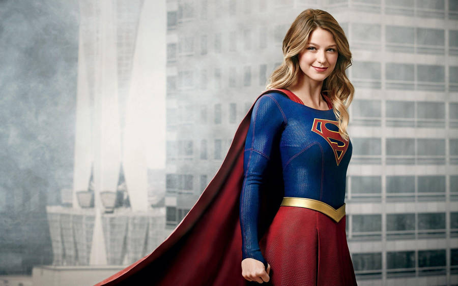 Smiling Supergirl In Building Wallpaper