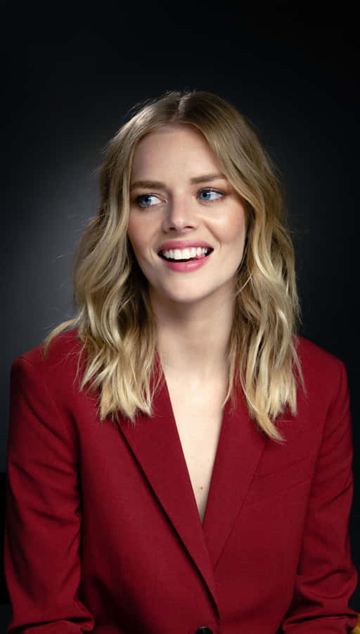 Smiling Womanin Red Blazer Wallpaper