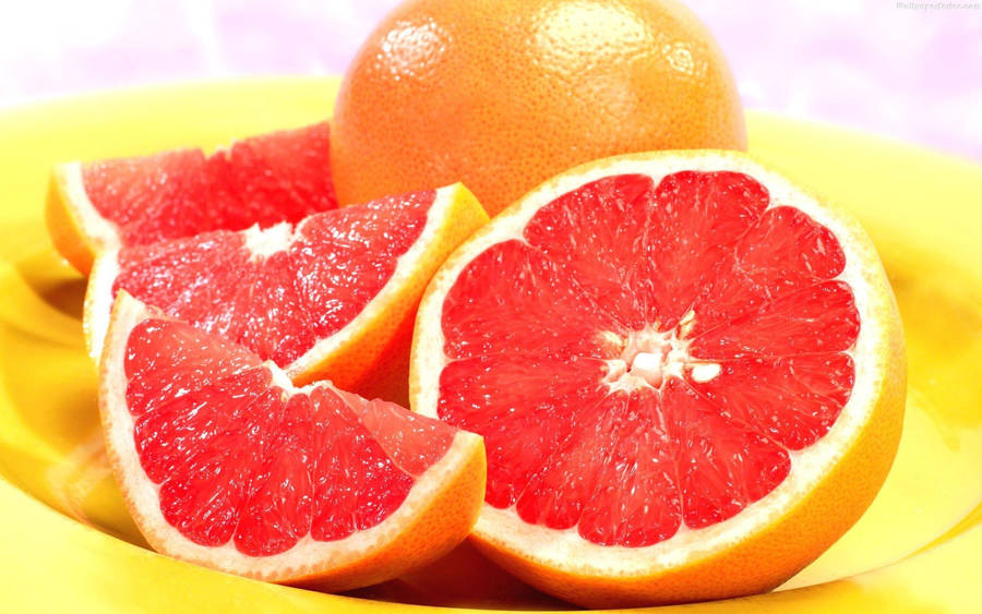 Soft Pink Grapefruits On A Plate Wallpaper