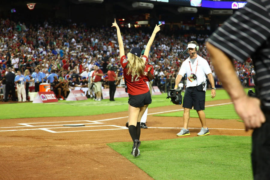 Softball Player Celebrating On The Field Wallpaper