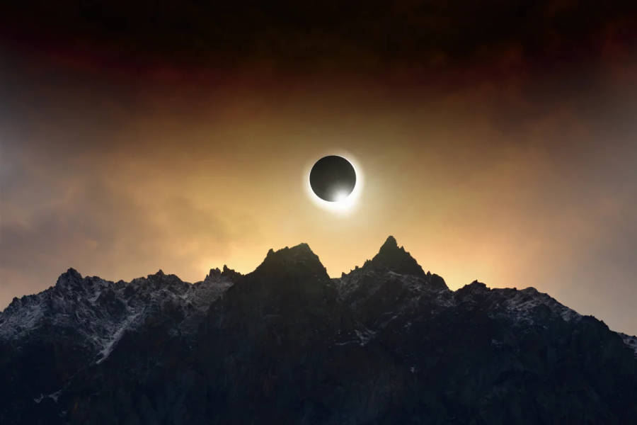 Solar Eclipse On Cloudy Mountaintop Wallpaper