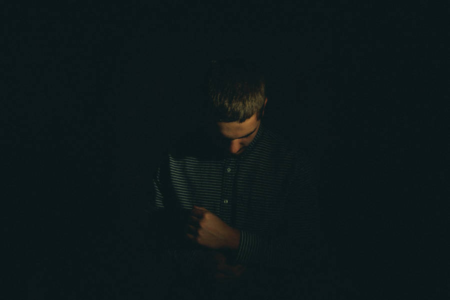 Solitude In Shadows - A Portrait Of A Sad Boy Wallpaper