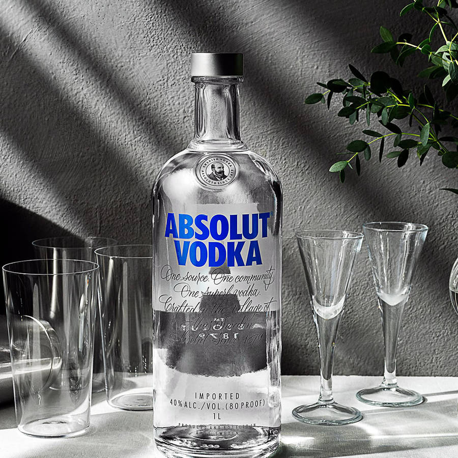 Sophisticated Absolut Vodka Bottle With Glasses In Black And White Wallpaper