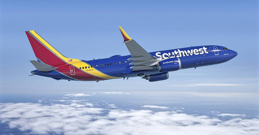 Southwest Airplane Soaring Above Clouds Wallpaper